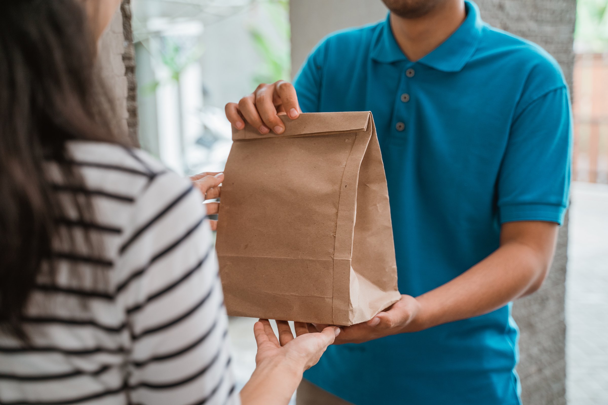 Delivery Man Delivering Food to Customer